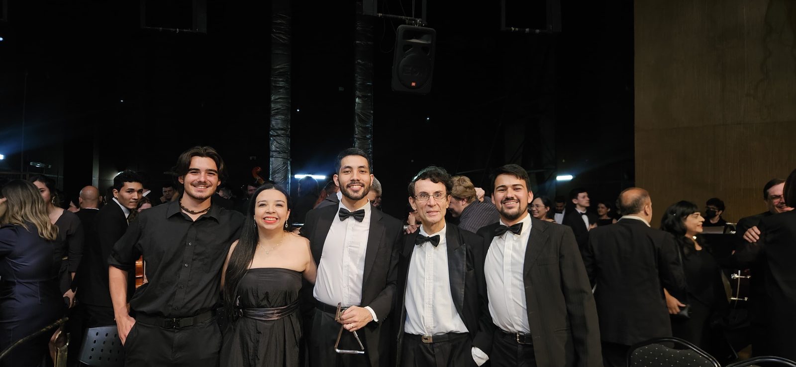 Makoa Lewis with fellow musicians of the Orquesta Sinfónica Nacional de Paraguay in concert attire after a performance