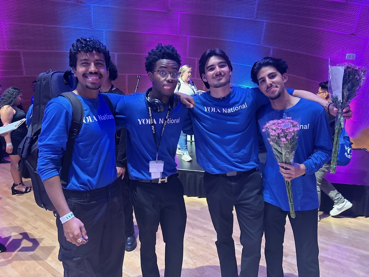 Makoa Lewis with fellow YOLA National musicians in matching blue shirts after a concert